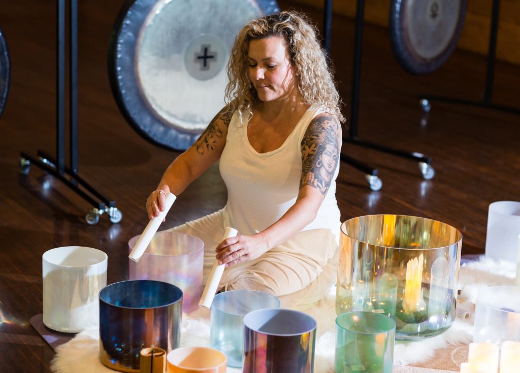 Woman playing alchemy bowls.